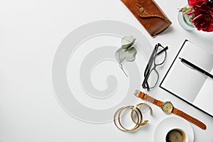 Top view of jewelry, notepad, pen