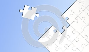 Top view of jigsaw puzzle with one piece left on blue background
