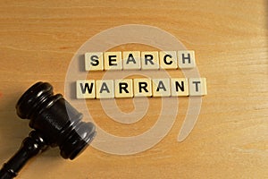 Top view of judge gavel and alphabet letters with text SEARCH WARRANT