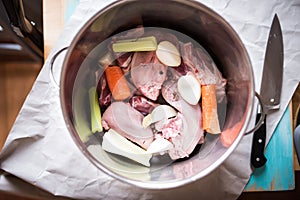 Top view of a kettle with meat, tongue, vegetables and spices photo