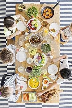 Top view on kids eating healthy dinner during birthday