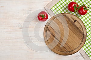 Top view of kitchen cutting board over wooden background