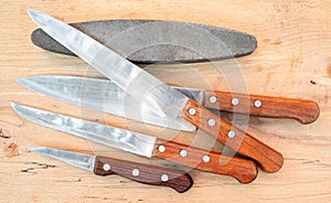 Top view of kitchen knives and sharpening stone