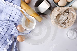 Top view of kitchen table, ingredients for dough and making bakery goods,products.Empty space for your text