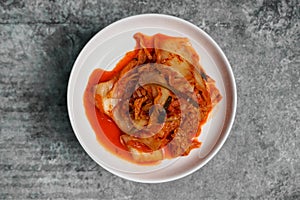 Top view Korean sliced cabbage kimchi on gray concrete table