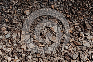 Top view of a lake with clean water and a pile of rocks lying on the ground underwater