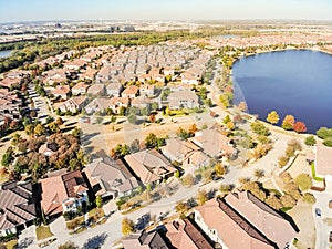 Top view lakeside Dallas suburban sprawl with new development residential house and city skylines