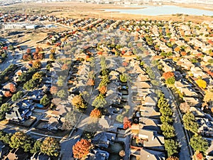 Top view lakeside residential subdivision houses with colorful autumn leaves near Dallas, Texas