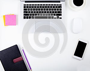 Top view of laptop computer with open display screen monitor, mouse and notepad and notebook and smart mobile phone