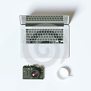 Top view laptop photo camera and coffee cup