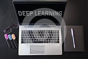 Top view of laptop with text Deep learning. Deep learning inscription on laptop screen