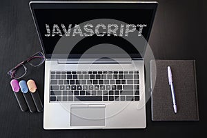 Top view of laptop with text Javascript. JavaScript inscription on laptop screen and keyboard. Learn programming language,