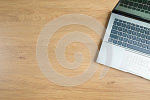 Top view of laptop on wooden table, copy space