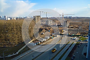 Top view of a large construction site with cranes and buildings houses concrete monolithic frame panel multi-storey