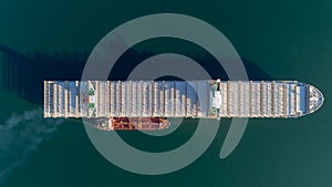 Top view of a large empty container ship and a tanker standing side by side.