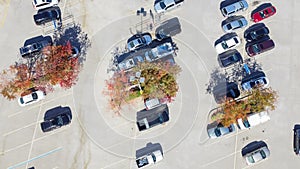 Top view large parking lot with return shopping cart area and beautiful fall leaves near Dallas, Texas, USA