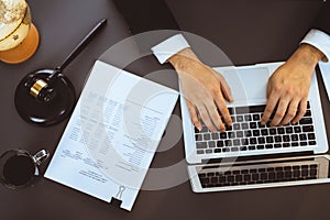 Top view lawyer working on his desk with laptop at law firm. Equilibrium