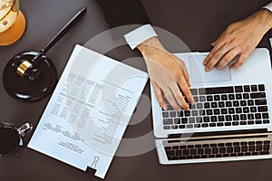 Top view lawyer working on his desk with laptop at law firm. Equilibrium