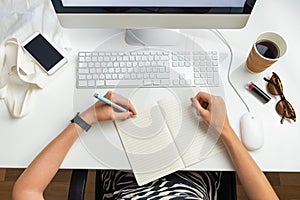 Top view of left handed business woman in minimalistic office. O photo