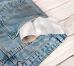 Top view leftovers Roll with toilet paper in pants pocket. Out of toilet paper, empty paper roll