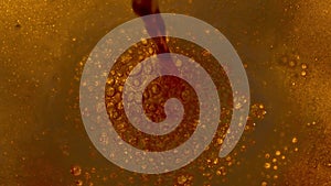 Top view of light beer being poured into a glass. Craft beer is poured into a mug forming foam and bubbles close up