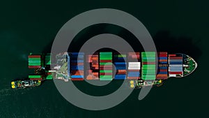 top view light and shadow of cargo container ship sailing in sea to import export goods and distributing products to dealer and