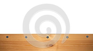 Top view light wood texture surface with natural pattern and metal nail heads or hats. Wooden pine board isolated on white. Spruce