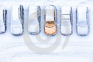 Top view at line from parked cars with one warmed up, pre-heating system at winter season photo