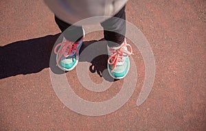 Little girl with sneakers and leggins training outdoors photo