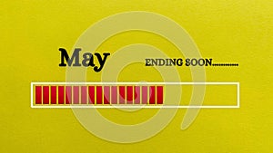 Top view of loading bar showing the end of May month with yellow paper background.