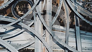 Top view lockdown shot of traffic moving through incredible complex multiple level road interchange in Los Angeles, USA.