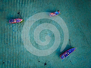 Top view Longtail fishing boats in the tropical sea at Rawai beach Phuket Thailand, Beautiful sea surface High angle view from