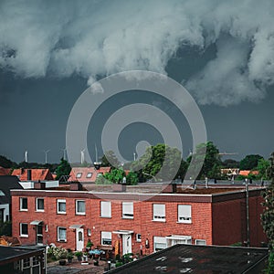 Top view of look-alike resindeital buildings, houses with red birck captured under a gloomy grey sky