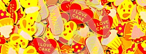 Top view of lots of colourful foam stickers depicting hearts, butterflies and cupcakes. Summer or joy concept. Facebook banner.