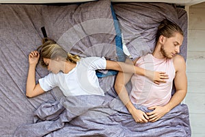 Top view - a loving couple is sleeping in bed. Recovery and healthy sleep concept.