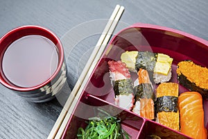 Lunch box served with soy sauce and chopsticks