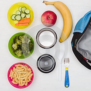 Top view on lunch box, thermos and healthy food options for school. Snacks for the day. Hot lunch, take away.