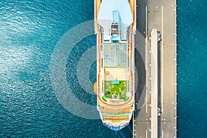 Top view of luxury cruise ship with golf field on the roof at anchor moored in marina on the blue water of Adriatic Sea