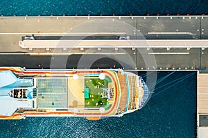 Top view of luxury cruise ship with golf field on the roof at anchor moored in marina on the blue water of Adriatic Sea