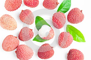 Top view: lychee fruits with green leaves on white background