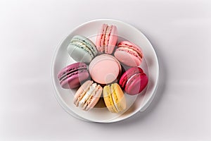 Top View Macarons On Round Plate On Wihte Backgound