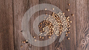 Top view macro close-up on plenty of dry cardamom spice on wooden background, horizontal format, with copy space for text