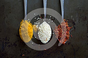 Top View Macro Image of Spoons with Saffron, Sesame Seeds and Curcuma