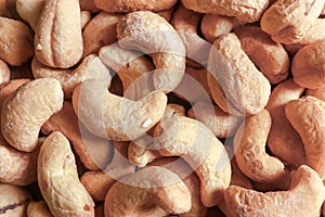 Top view macro shot of group roasted cashew nuts background. Healthy foods or diet concept