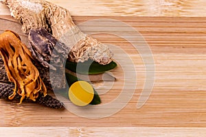 Top view macro shot of herbal pills and tablets arranged with spices on a red stone. Unani medicines concept