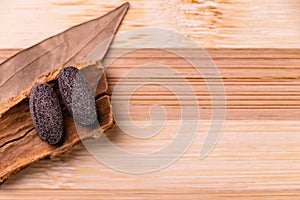 Top view macro shot of herbal pills and tablets arranged with spices on a red stone. Unani medicines concept