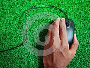 wired black color computer mouse. Isolated on green background