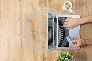 Top view of male hands making an online payment