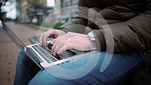 Top view male hands using notebook outdoors in urban setting while typing on keyboard. .4k