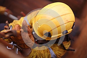 Top view of male rope access technician wearing yellow rope access full protection safety helmet